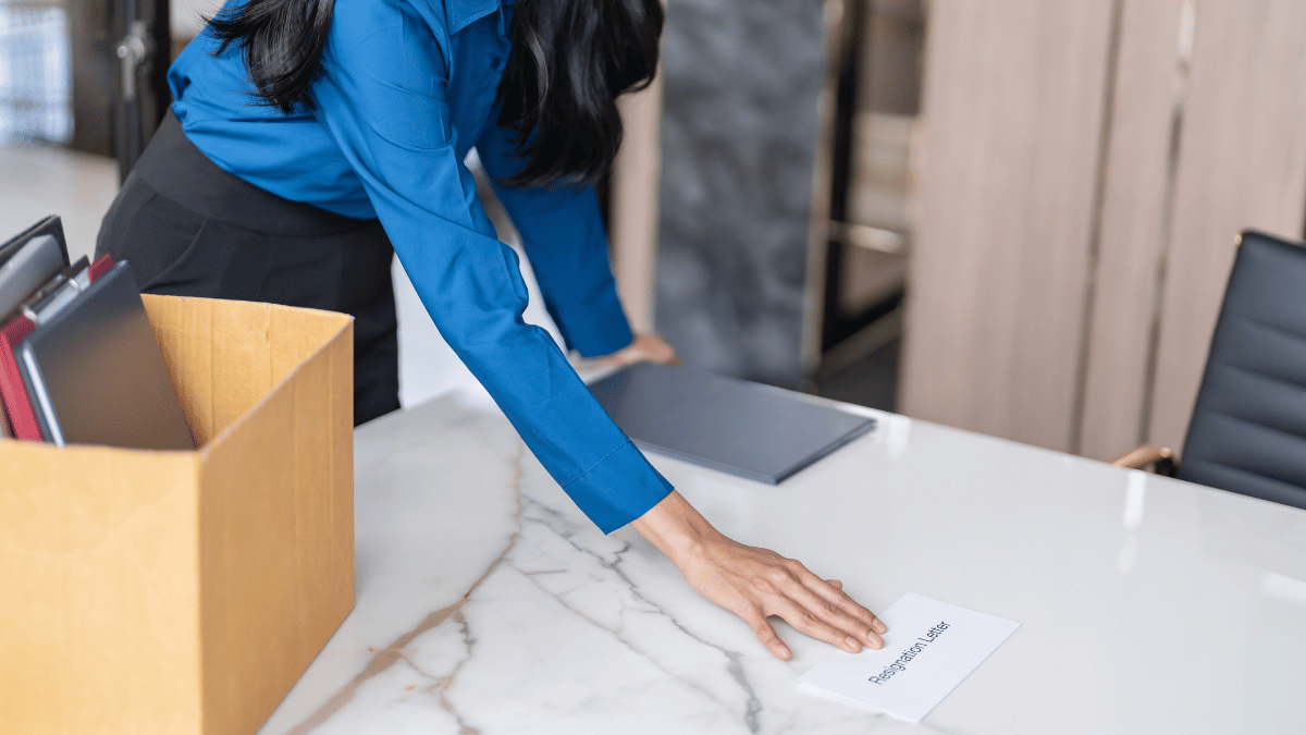 woman giving her resignation letter at work